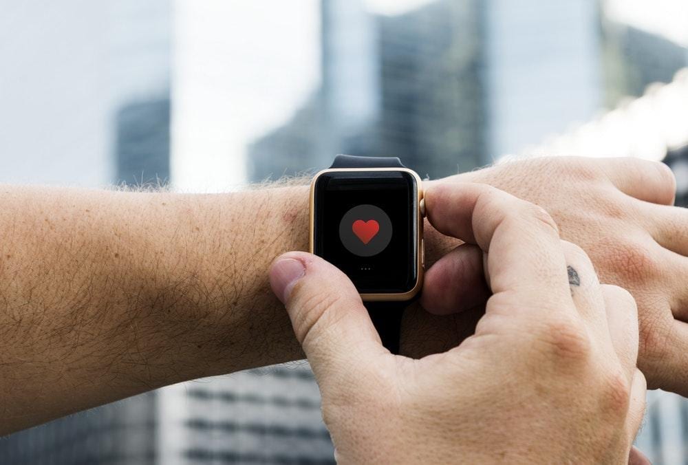 person holding Apple Watch during daytime